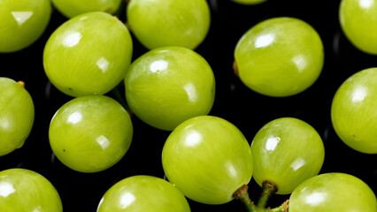 Green grapes on black background