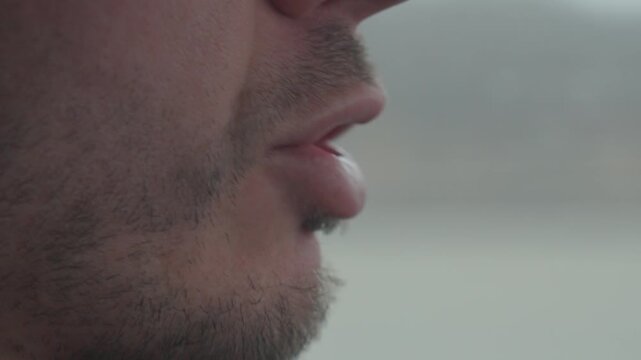 Close up view of man mouth and chin with facial hair while talking. Process of person speaking with moving lips