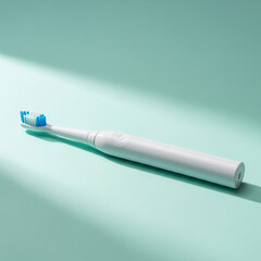 White Electric Toothbrush on Mint Green Background