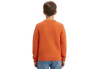 Young boy wearing orange sweater and blue jeans facing away from camera isolated on black isolated on transparent background
