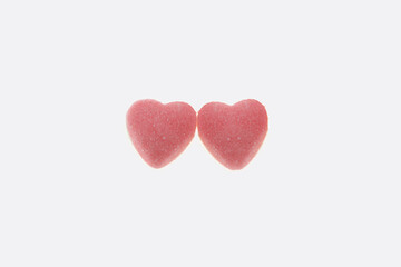 two pink heart candies, sweet candy heart photo, minimal valentine&rsquo;s day concept, romantic pink candy art, minimalist photo of two pink heart candies placed side by side,  isolated on white background