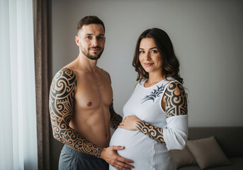 Pregnant woman with tattooed partner in white dress at home. Alternative couple maternity session for modern prenatal care and family planning services