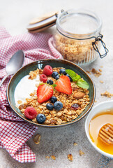 Granola yogurt parfait with fresh berries and honey