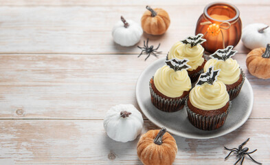 Halloween cupcakes decorated with bats and spooky pumpkins