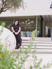 Confident Asian woman with real body smiles while enjoying casual day out. Body positive concept.