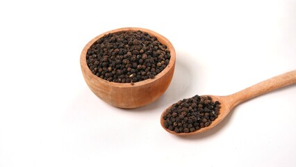 Black Peppercorns in Wooden Bowl and Spoon on White