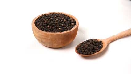 Black Peppercorns: Wooden Bowl and Spoon on White