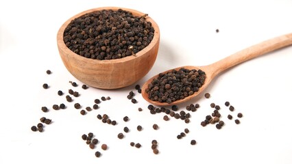 Black Peppercorns in Wooden Bowl and Spoon on White