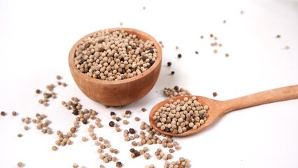 White Peppercorns: Aromatic Spice in Wooden Bowl and Spoon