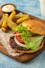Smash burger with cheddar cheese and caramelized onions, served with fries