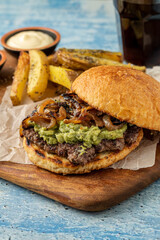 Smash burger with cheddar cheese and caramelized onions, served with fries