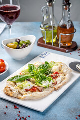 Italian flatbread with salad and wine