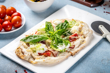 Italian flatbread with basil, lettuce, and tomatoes