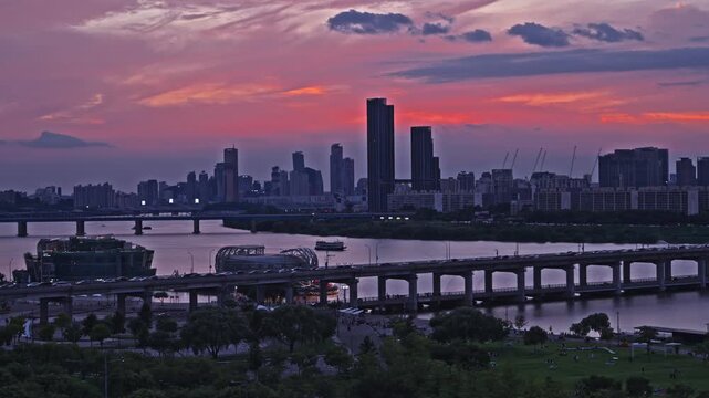 Stunning cityscape of Seoul South Korea with the Banpo Bridge and Han River under a dramatic and colorful red sunset sky at twilight