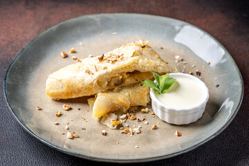 Apple strudel with vanilla sauce and mint