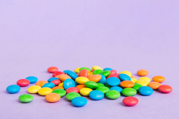 Pile of delicious colorful sweet candies on colored background top view. Confectionery decor