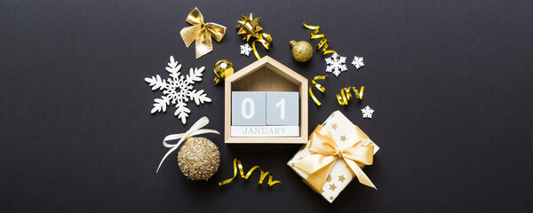 Christmas calendar 1 january. Christmas gift, fir branches, pine cones. Flat lay, top view. New Year decorations on a colored background