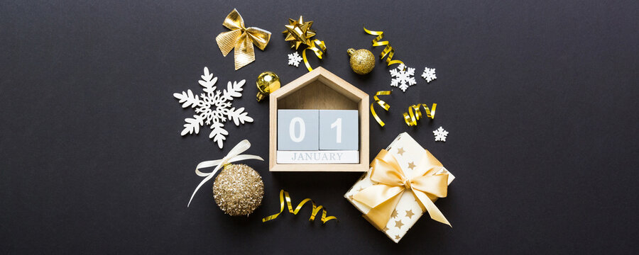 Christmas calendar 1 january. Christmas gift, fir branches, pine cones. Flat lay, top view. New Year decorations on a colored background