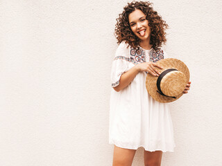 Beautiful smiling model with afro curls hairstyle dressed in summer hipster white dress.Sexy...