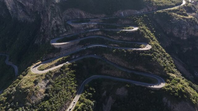 Top-down aerial of the famous Leba Pass switchbacks, showcasing its unique curves carved into the rugged Angolan mountain
