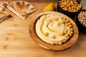 Hummus in bowl, houmous dip, chickpea humus tahini sauce, middle eastern spread