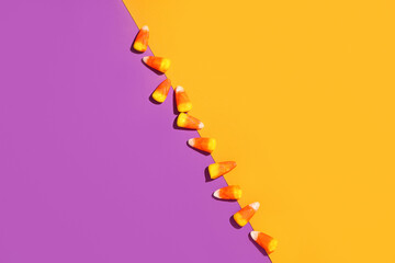 Sweet candy corns on colorful background. Halloween celebration