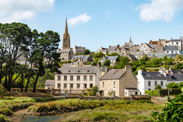 Scenic French Village of Pont-Croix, in Brittany, With River, Stone Homes, Green Hills, and a Dominant Tall Church Spire