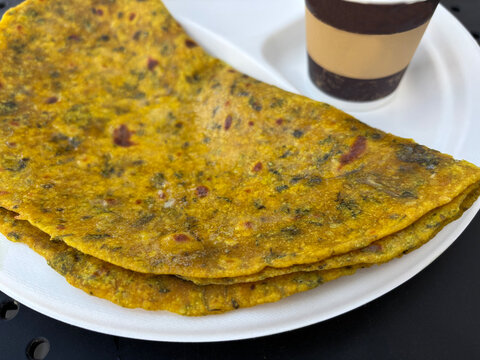 Indian paratha with masala tea. Layered flat bread with greens, hot naan, roti or chapati