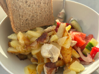 A popular Slavic food in the form of fried potatoes with chicken fillet and salad