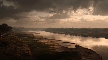 Obraz premium Reflective River Landscape under Dramatic Cloudy Sky
