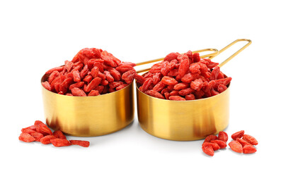 Spoons with red dried goji berries on white background