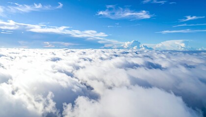 Naklejka premium High white cumulus clouds drift over the blue mountain landscape in the clear day air
