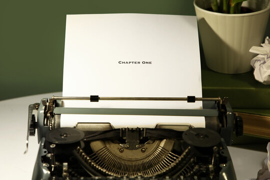 Vintage typewriter on table in dark office, closeup