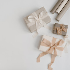 Gift boxes packaging on white background. Festive Christmas, New Year holidays celebration concept. Flat lay, top view