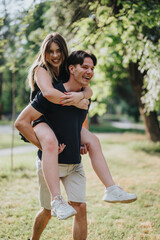 A happy couple spending quality time outdoors, with the woman joyfully piggyback riding on her...