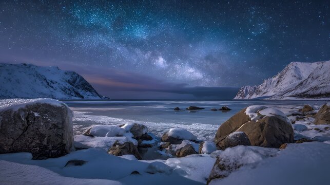 Frozen coastline with snow-laden mountains under a vibrant Milky Way