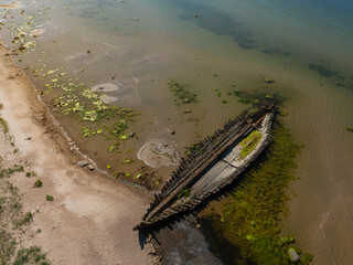 Aerial top-down view of the historic Raketa schooner shipwreck near Loksa, Estonia. Rusted remains...