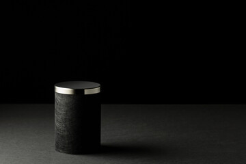 Black podium on a black background.