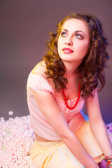 Fototapeta premium Closeup Portrait of Sensual Young Caucasian Female in Colorful Clothing in Dolly Style Against Color Background.