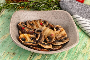 Tasty hot grilled champignon mushrooms