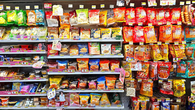 Snack Aisle in 7-eleven Store: An enticing display of a variety of snack options, neatly arranged on shelves in a well-stocked grocery store. Thailand, October 8, 2025