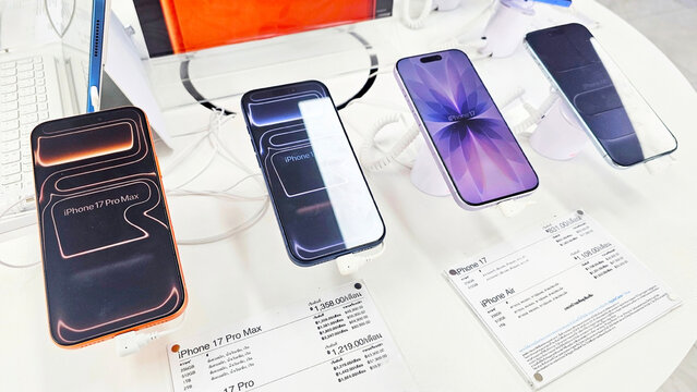 Mobile Phone Showcase: A display of multiple iPhone 17 models with pricing information, showcasing the latest technology in a retail environment. Thailand, October 8, 2025