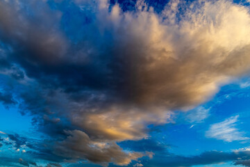 Dramatic illuminated cloud at sunset