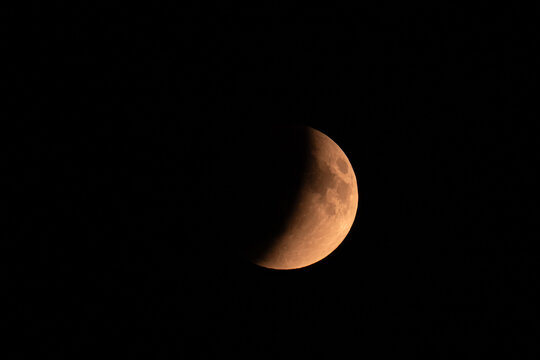 red moon during a lunar eclipse, autumn evening, dark sky
