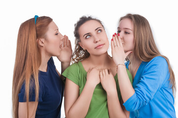 Company of Three Expressive Winsome Young Funny Caucasian Girlfriends Sharing Their Secrets Whispering to Ears.Isolated Over White
