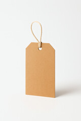 Front view of kraft paper tag with rope string isolated on clean white background, eco-friendly label for handmade product, sustainable packaging, natural branding design, minimalist studio mockup