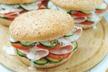 Bun sandwiches with salami and vegetables