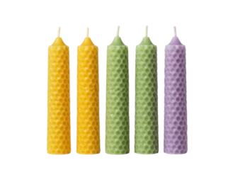 Colorful beeswax candles isolated, set of five decorative candles in yellow, green and purple colors, handmade honeycomb texture