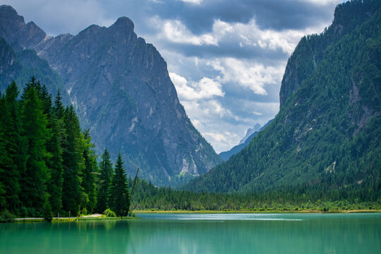 Lake Dobbiaco with emerald green water mirroring mountains