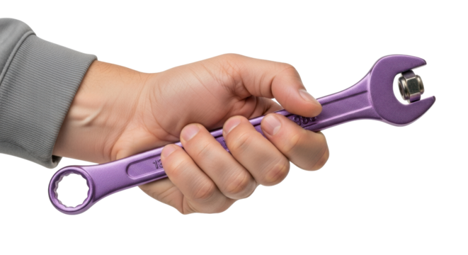 Isolated person holds purple wrench tightening a nut; repair work, construction, home maintenance